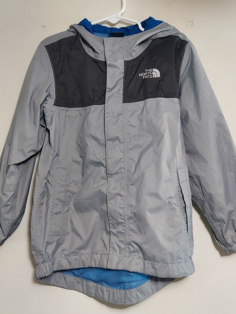 The North Face Kids' Light Gray and Black Hooded Raincoat with Blue Lining